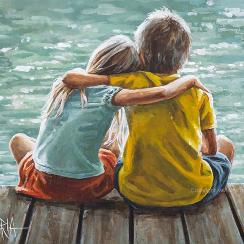 Two children sitting on a dock by a body of water, embracing.