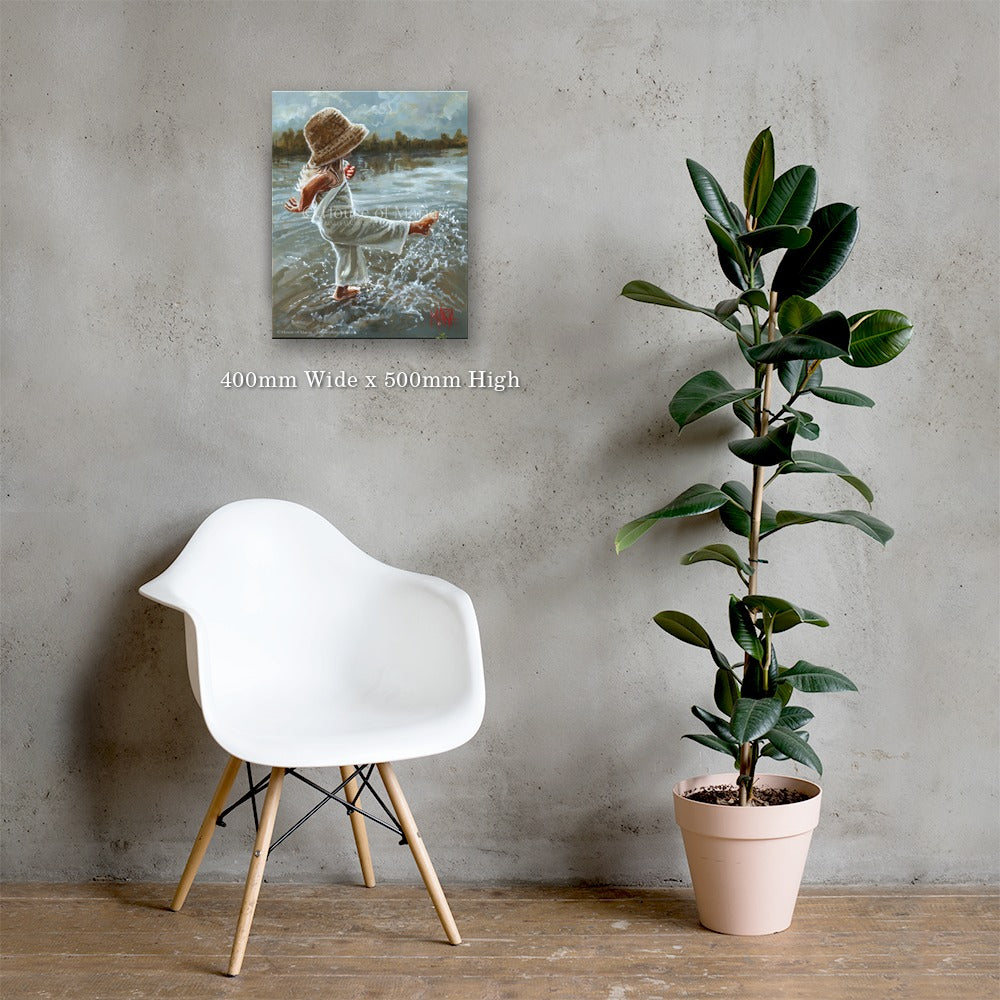 Lost in the Moment — a little girl in a straw hat splashing barefoot in the water by Maria Magdalena Oosthuizen, 400 x 500mm canvas print on a grey wall | canvas print wall art | House of Maria