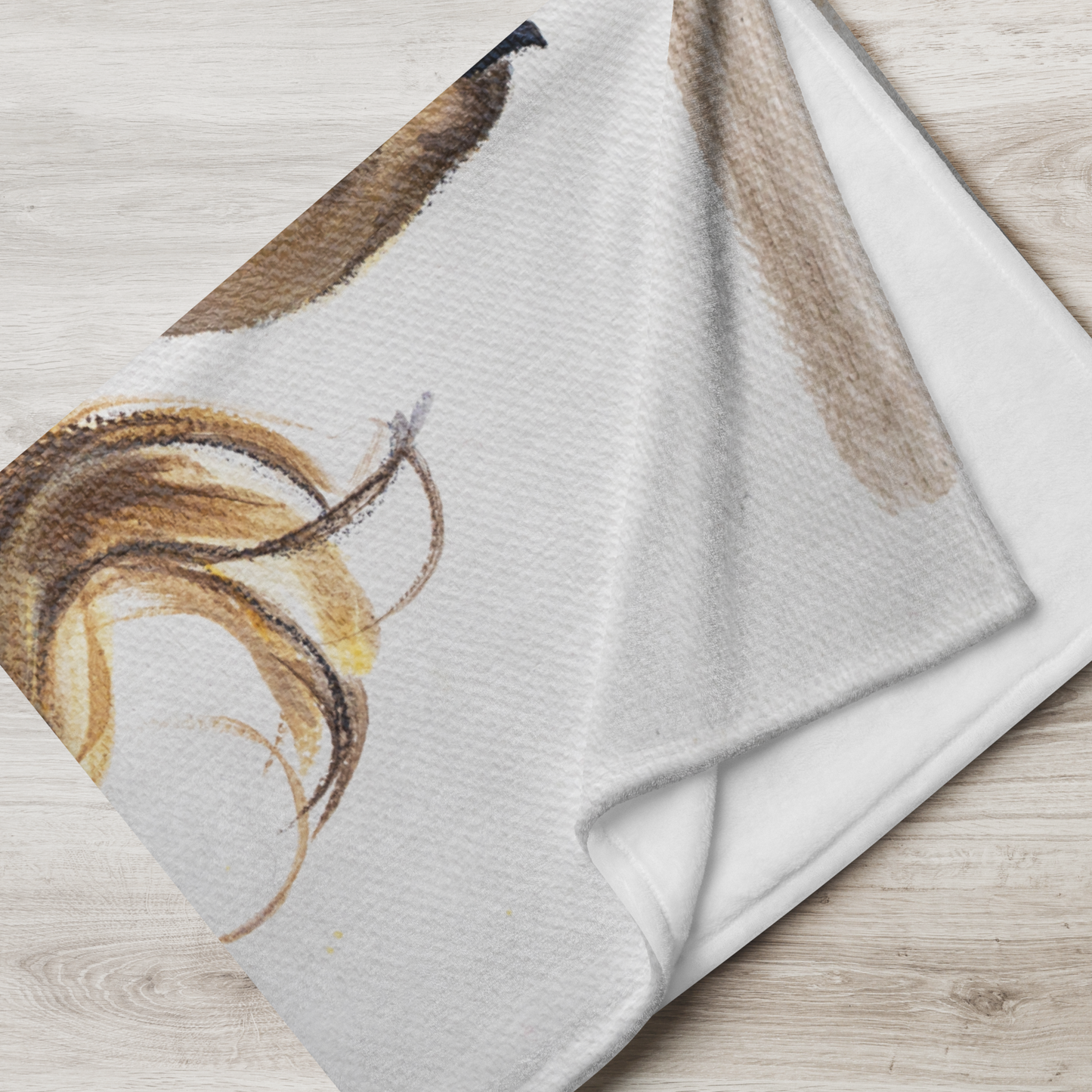 Textured fabric with abstract brown design on a light wooden surface