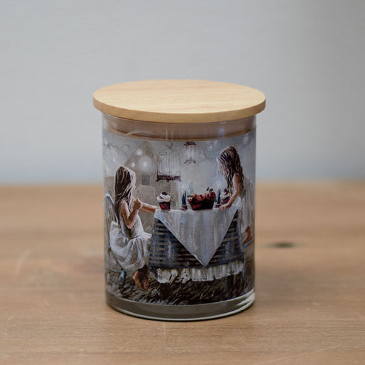 A vanilla scented wax candle with a cotton wick, placed in a clear whisky glass jar with a wooden lid, featuring a vanilla bean design.